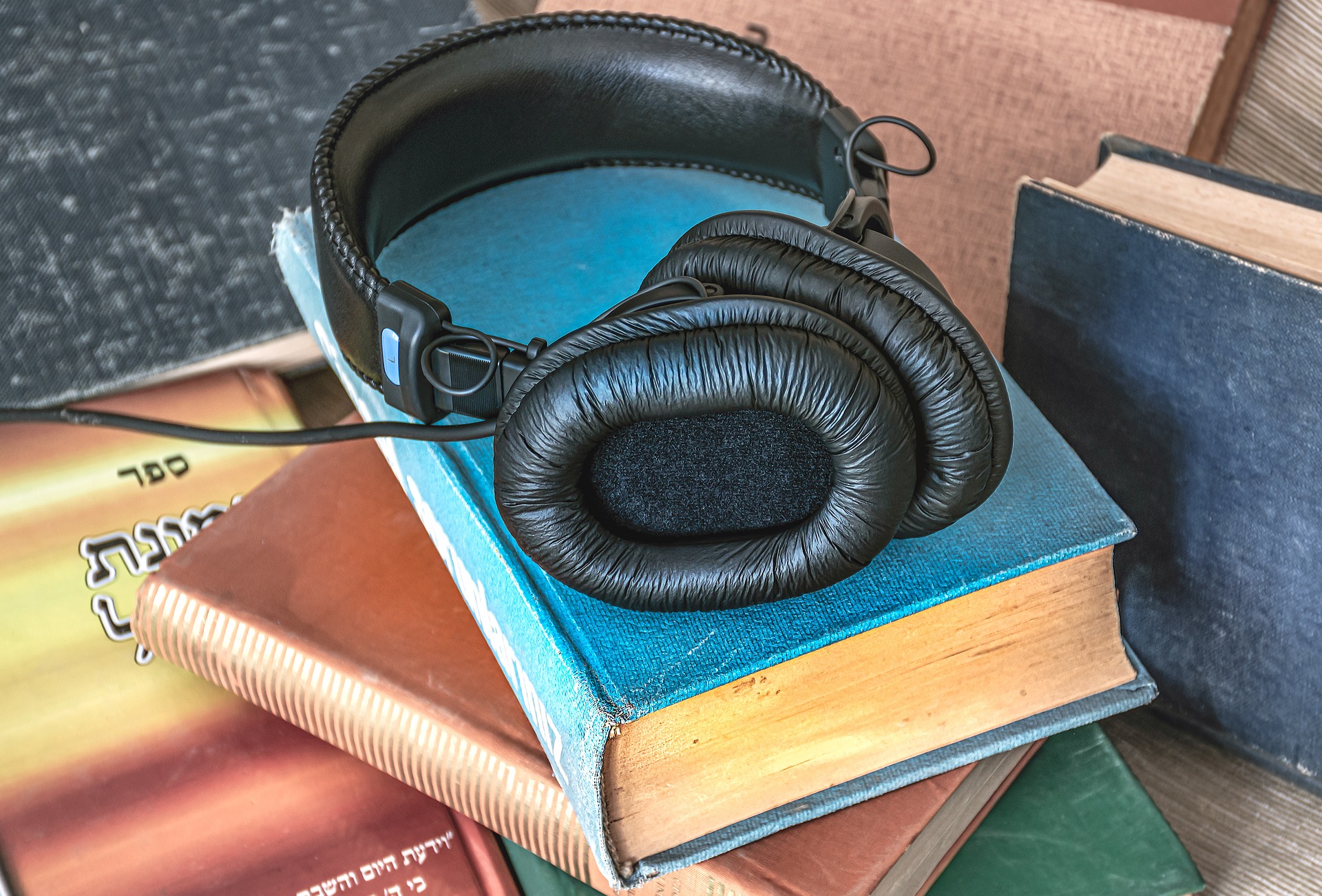 Books and headphones representing the Audiobook Narration article.